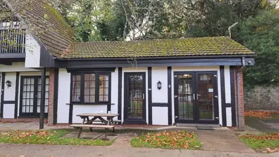 a small building with a picnic table in front of it at 14 Tudor Court, Tolroy Manor in Hayle