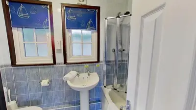 a bathroom with a sink and a shower at 14 Tudor Court, Tolroy Manor in Hayle