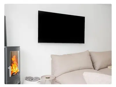 a living room with a couch and a fireplace at Newly Refurbished Beach Lodge in Looe