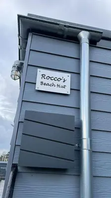 a sign on the side of a building at Newly Refurbished Beach Lodge in Looe
