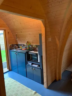 a small kitchen with blue cabinets and a stove at Silverspring Hideaways in Constantine