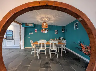 a dining room with a wooden table and chairs at The Old Barn near St Ives - Rustic Charm & Space in St Ives