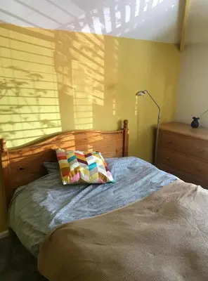 a bed with two pillows on it in a bedroom at The Old Barn near St Ives - Rustic Charm & Space in St Ives