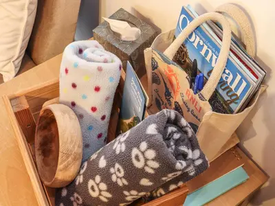 a wooden box filled with socks and other items at Owl Cottage in Looe