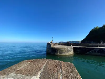a pier in the water next to the ocean at Carole's Cottage - Private Parking, Sea Views, Garden & Close To Harbour & Beach in Charlestown