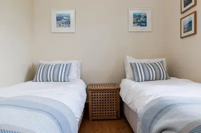 two beds sitting next to each other in a room at Little Hendra at Hendra Barns in Newquay