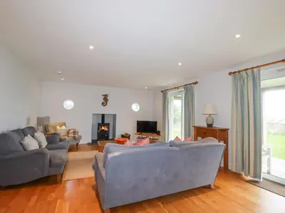a living room with two couches and a fireplace at Freefolk in Wadebridge
