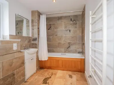 a bathroom with a tub and a sink at Freefolk in Wadebridge