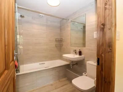 a bathroom with a tub and a sink and a toilet at Jasmine cottage in Liskeard