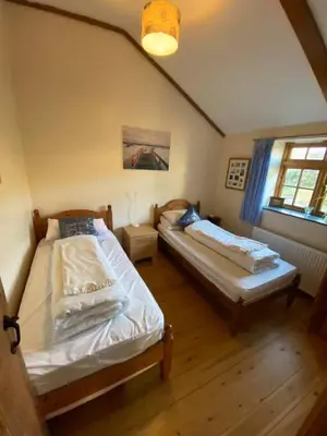 a bedroom with two beds in a room at Sundance Cottage Sleeps 4 in Camelford