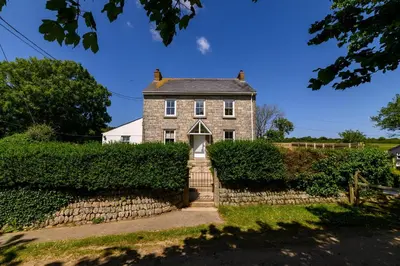 an old stone house with a staircase leading to it at Family Friendly Apartment above Praa Sands Beach in Praa Sands