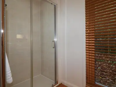 a shower with a glass door in a bathroom at 3 Hedgerows in Looe