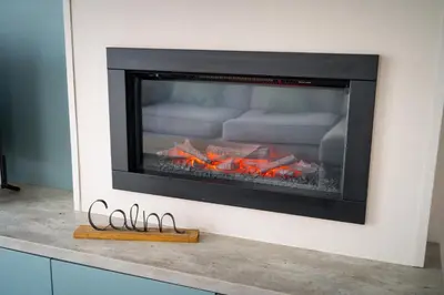 a fireplace in a living room with flames in it at Valley View - Newquay Bay Resort near Porth Beach in Newquay