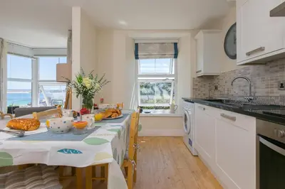 a kitchen with a table with food on it at Captain's Rest in St Ives