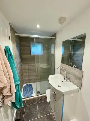 a bathroom with a shower and a sink at The Shack 1 bedroom apartment in Newquay