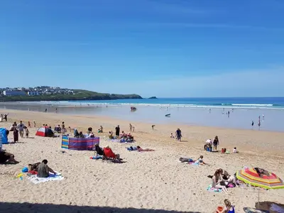 a group of people laying on a beach at OYO Minerva Guesthouse in Newquay