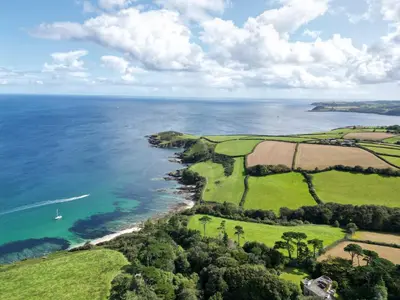 an aerial view of the coast of the ocean at Bream Barn - sea view, woodburner, easy walk to the beach, parking, full kitchen in Falmouth