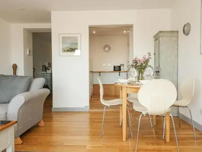 a living room with a table and chairs and a couch at Catch the Wave in Newquay