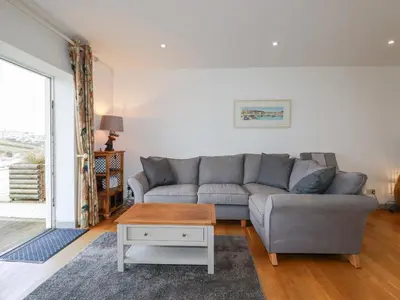 a living room with a couch and a table at Catch the Wave in Newquay