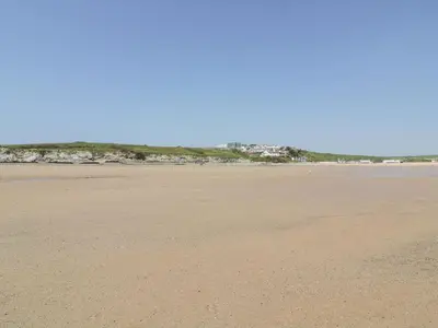 an empty beach with the ocean in the background at Catch the Wave in Newquay