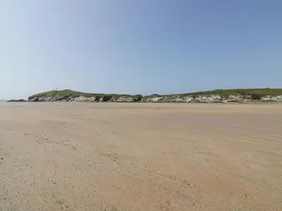an empty beach with footprints in the sand at Catch the Wave in Newquay
