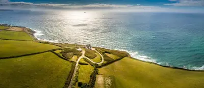 an aerial view of the ocean and a road at Beacon Crag in Porthleven