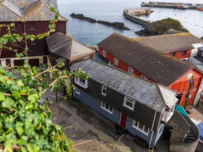 an overhead view of a row of houses next to the water at Apartment Harbourside Hideaway by Interhome in Mevagissey