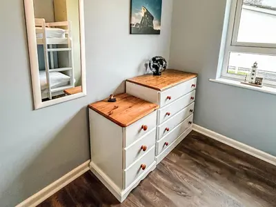 a bedroom with a white dresser with a wooden counter at Chalet Kingfishers Lodge by Interhome in Liskeard