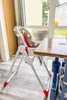 a high chair sitting next to a table at Chalet Kingfishers Lodge by Interhome in Liskeard