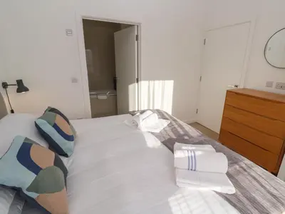 a bedroom with a bed with towels on it at Una, Lodge 70 in St Ives