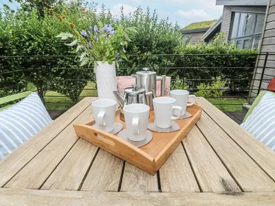 a wooden tray with cups and coffee makers on a table at Una, Lodge 70 in St Ives
