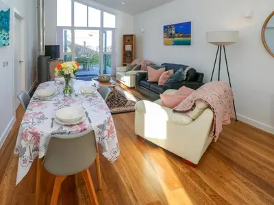 a living room with a table and a couch at Una, Lodge 70 in St Ives