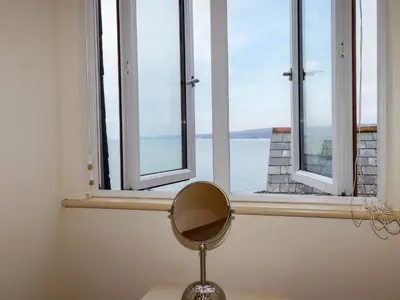 a mirror sitting on a desk in front of a window at Blue Horizon in Port Isaac