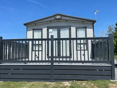 a small white house with a black fence at Summer Days at Seven Bays Padstow in Padstow