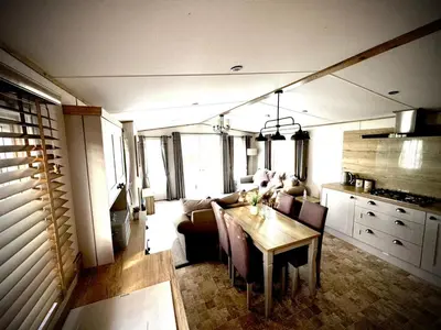 a kitchen and dining room with a table in a house at Summer Days at Seven Bays Padstow in Padstow