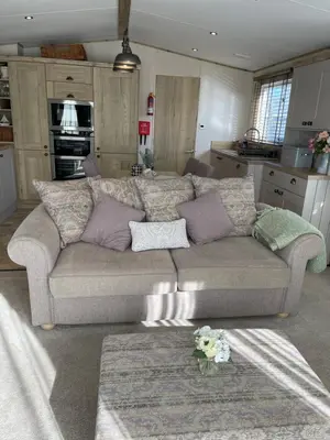 a living room with a couch with pillows on it at Summer Days at Seven Bays Padstow in Padstow
