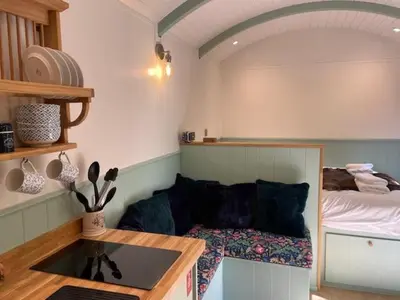 a living room with a couch and a bed at Waters Meet in Warleggan
