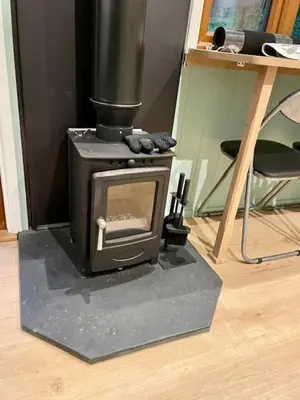 a stove sitting on the floor in a room at Waters Meet in Warleggan
