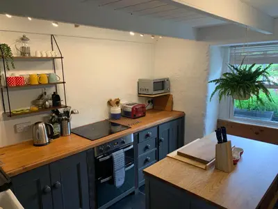 a kitchen with blue cabinets and a counter top at Kernyk in Redruth