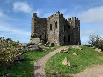 an old castle on a hill with a dirt road at Kernyk in Redruth