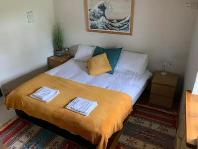 a bed with two pillows on it in a room at Kernyk in Redruth