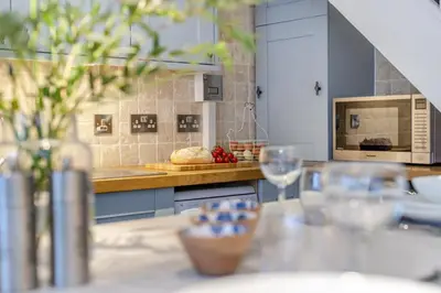 a kitchen with a counter with a table with wine glasses at 2 Bed in Fowey oc-r30265 in Fowey