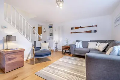 a living room with a couch and chairs and stairs at 2 Bed in Fowey oc-r30265 in Fowey