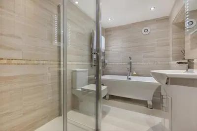 a bathroom with a tub and a toilet and a sink at 2 Bed in Fowey oc-r30265 in Fowey