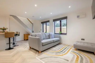 a living room with a couch and a chair at 2 Bed in Padstow oc-t30497 in Padstow