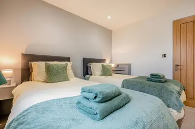 a bedroom with two beds with blue towels on them at 2 Bed in Padstow oc-t30497 in Padstow