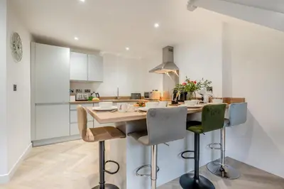 a kitchen with a wooden table and chairs at 2 Bed in Padstow oc-t30497 in Padstow