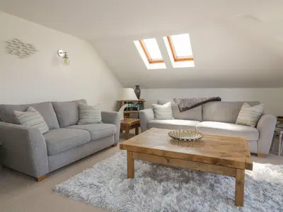 a living room with two couches and a coffee table at Atlantic View in Newquay