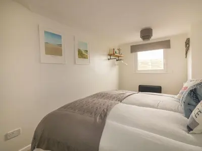 a bedroom with a bed and a window at Atlantic View in Newquay