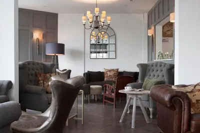 a living room with couches and chairs and a table at The Gannet Inn in St Ives